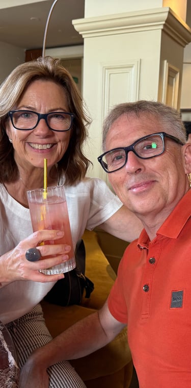 Two adults smiling at restaurant table with drinks and candle, enjoying relaxed social outing