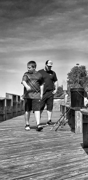 A man and boy come to fish the Fox River at the Montello Wisconsin dam. 