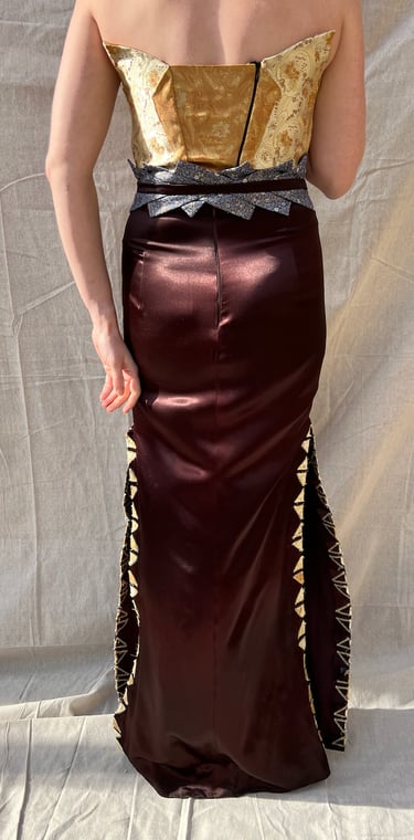 The full back of a gold brocade and brown satin evening gown