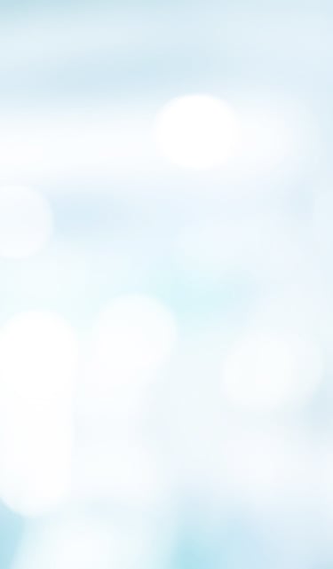 Soft light blue and white abstract bokeh background with blurred medical or office interior lighting.