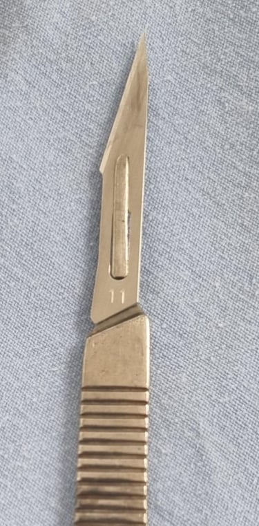 a knife and a knife blade on a blue cloth