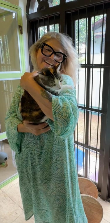 Lisa, founder of The Cat Residence Colombo, holding one of her resident cats with love and care.