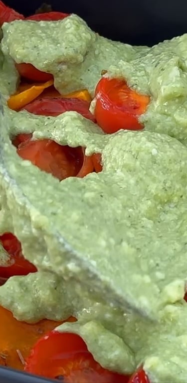 Spread the pesto cream evenly over the roasted vegetables