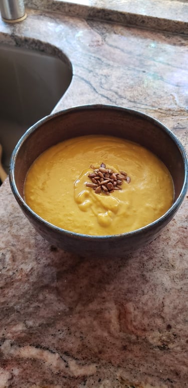 a bowl of soup with sunflower seeds in it
