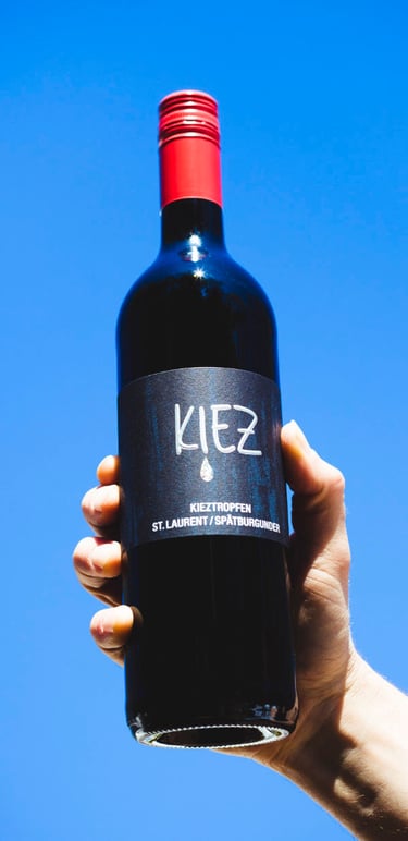 Wine bottle with a red screw top.