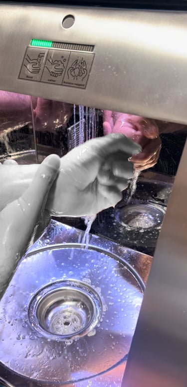a person is washing their hands in a sink