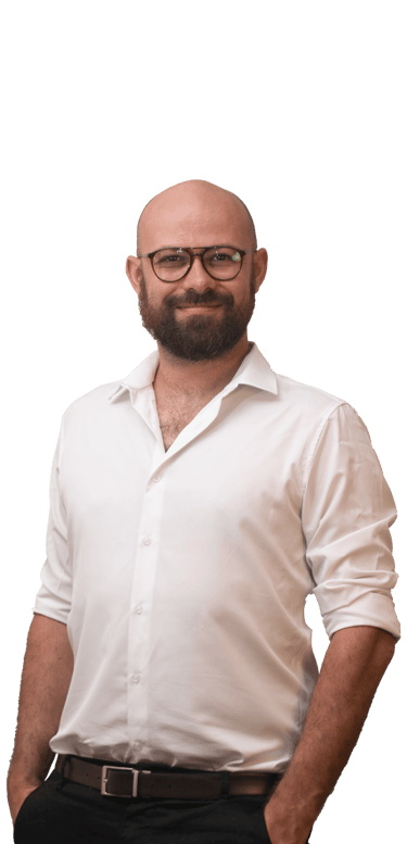 a man with a beard and glasses standing in front of a green background