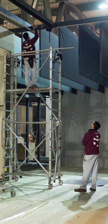 a man standing on a scaffold in a building