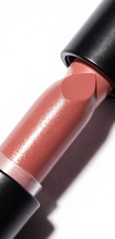 Clean image of lipstick and blush with soft lighting on a white background