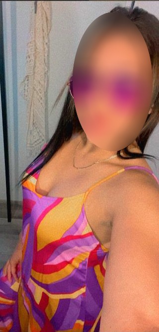 a woman with a large breast breast, wearing a colorful dress