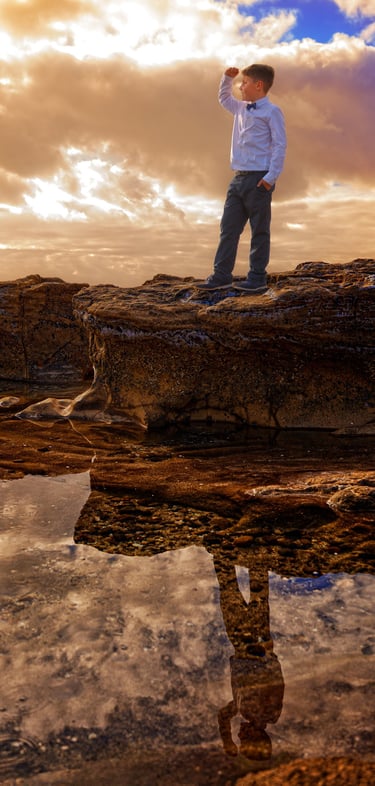 a man standing on a rock with a camera