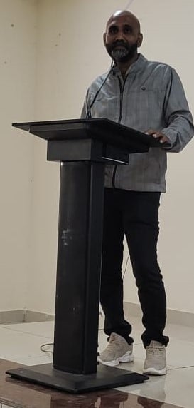a man standing at a podium with a microphone