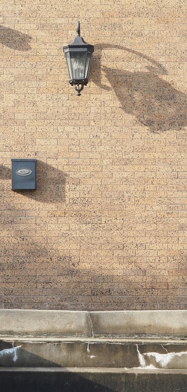 Speckled, light brown brick wall of the front of the Homard House/Ludwig Law Firm law offices. 