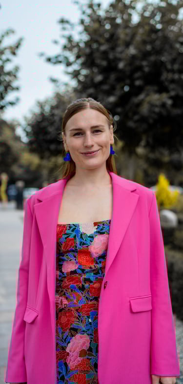 Bryllupsgæst i blomster skrædder kjole og pink blazer 