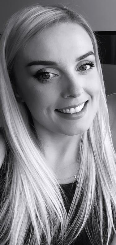 a woman with blonde hair and a black top