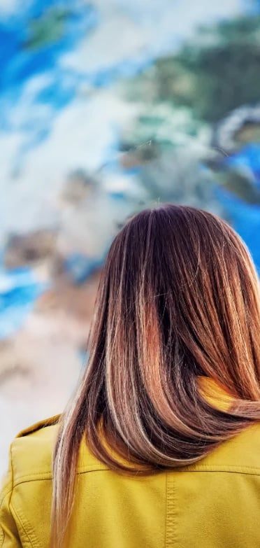 Woman staring at a large world map on a wall