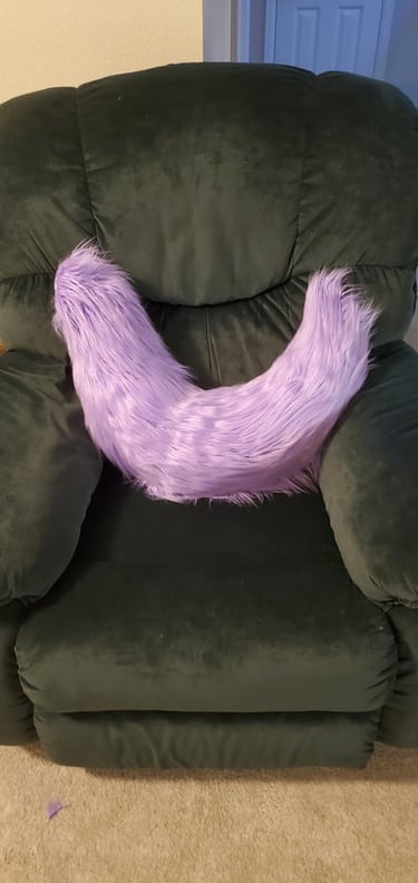 A fluffy purple tail made by Teto Creations