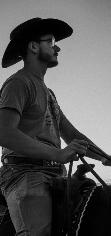 a man in a cowboy hat riding a horse