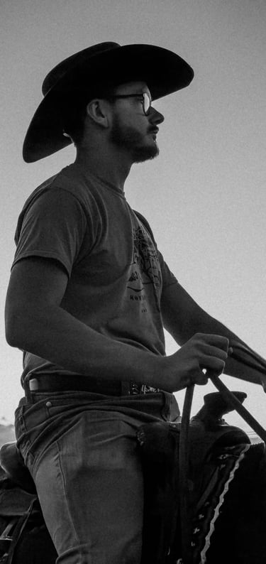 a man in a cowboy hat riding a horse