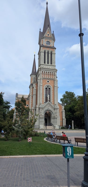 The historic Sacred Heart Jesuit Church in Budapest, Hungary, featuring Neo-Romanesque architecture and a tall spire.