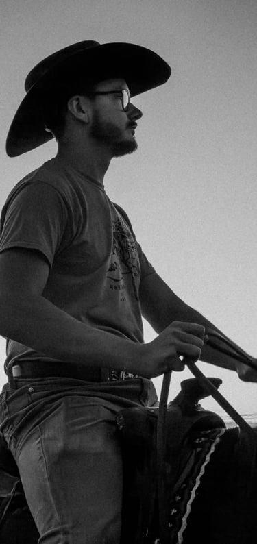 a man in a cowboy hat riding a horse