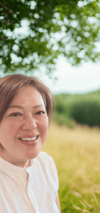 Alix in her element, surrounded by nature, embodies the grounded, nurturing care she offers clients