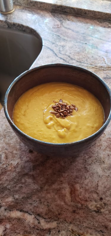 a bowl of soup with sunflower seeds in it