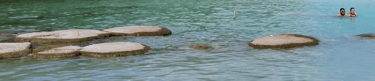 two people are swimming in a body of water