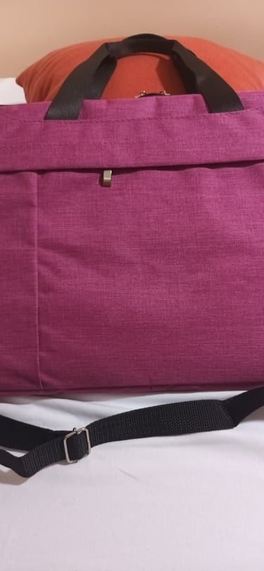 a laptop bag with a laptop on a bed