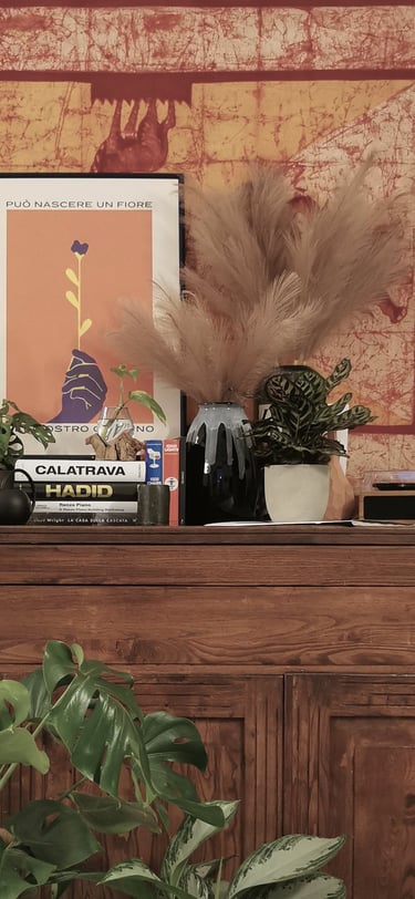 a dresser with a large tapestry hanging on a wall