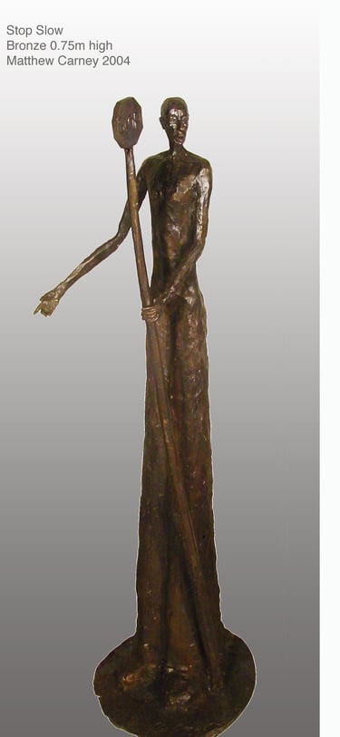 a sculpture of a workman holding a stop/slow sign