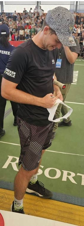 Dylan Frazier autographing a fan's hat