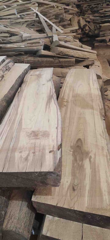 “Bulk collection of unfinished teak wood logs stacked for export in wholesale packaging”