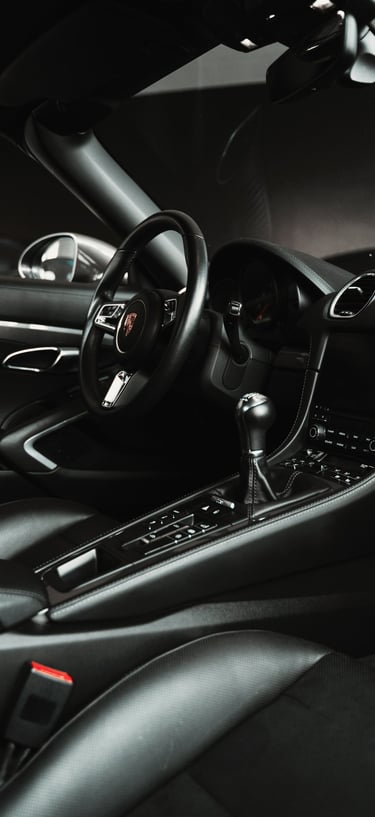 a car dashboard with a steering wheel and dashboard controls