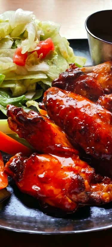 talíř s kuřecími křídly a salátem