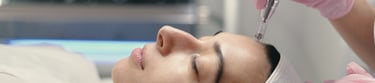 a woman is getting her face and neck examined by a doctor