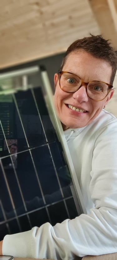 a man in a white shirt and glasses is holding a laptop