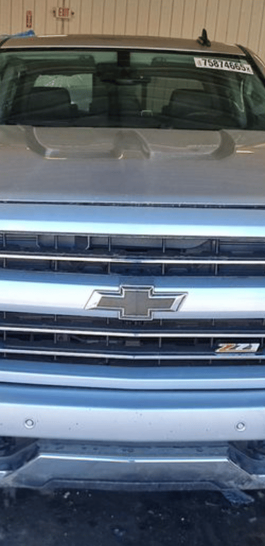 Front view of a silver Chevrolet Silverado Z71 pickup truck parked in a garage.