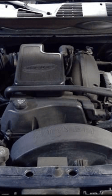 A detailed view of a General Motors Vortec 4200 engine inside a car engine bay.