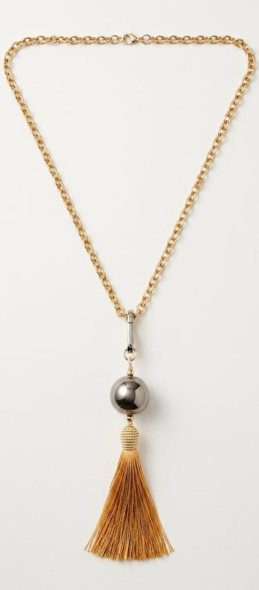 Elegant gold chain necklace featuring a grey metallic bead and a long yellow silk tassel pendant.