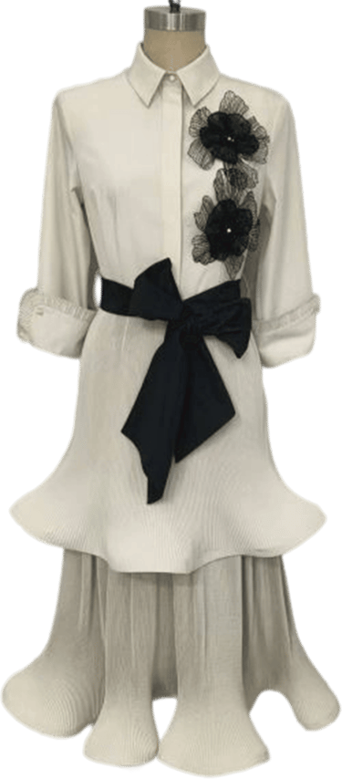 a dress with a black ribbon tied to a mannequin