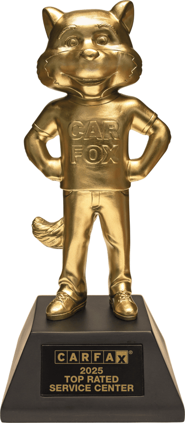 Gold CARFAX 2025 Top Rated Service Center trophy featuring the Car Fox mascot on a black base.