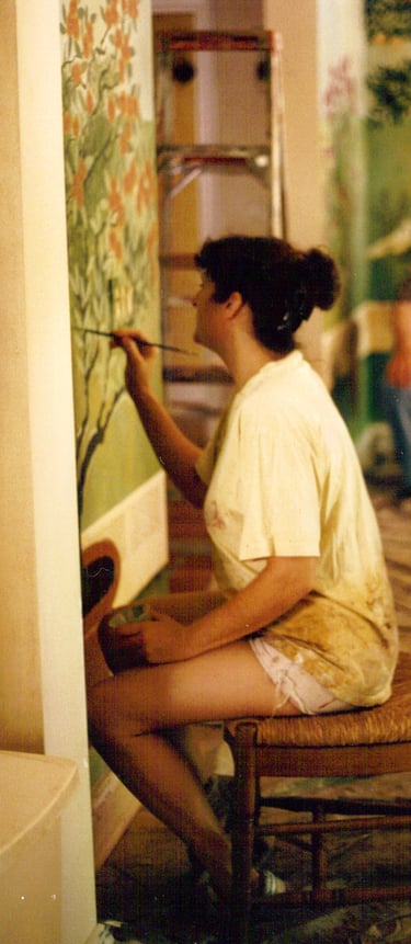 Christine painting a mural