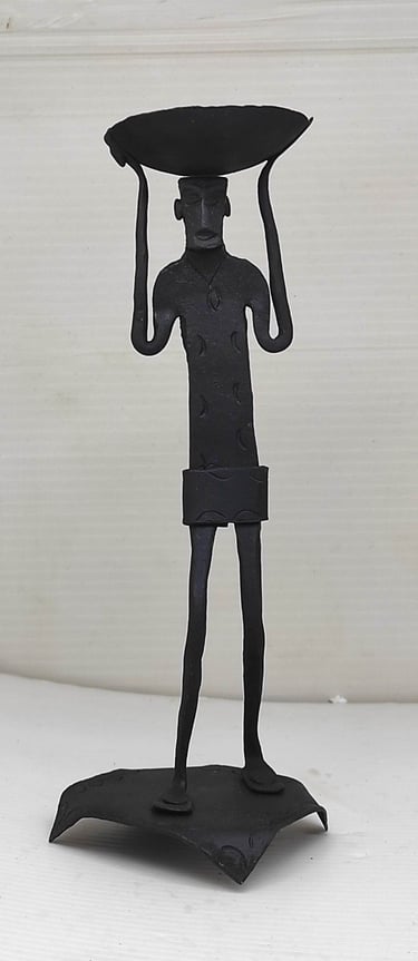 "Handcrafted iron tribal man sculpture with head load pad–standing view-for overseas markets"