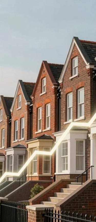 A rising arrow graph overlaid on a row of red brick terraced houses representing the UK real estate market growth.