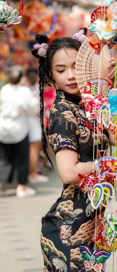 a woman in a traditional chinese dress and a fan