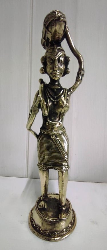 "Brass statue of a woman in attire carrying a pumpkin on her head and tools on her shoulder-For international dispatch