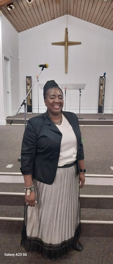 A woman standing in church smiling