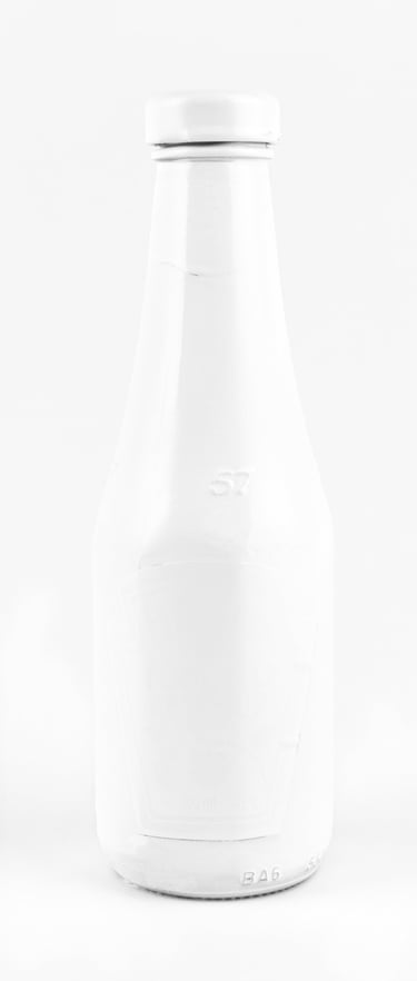 a white bottle of ketchup on a white background