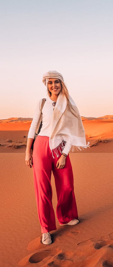 a woman in a white shirt and red pants